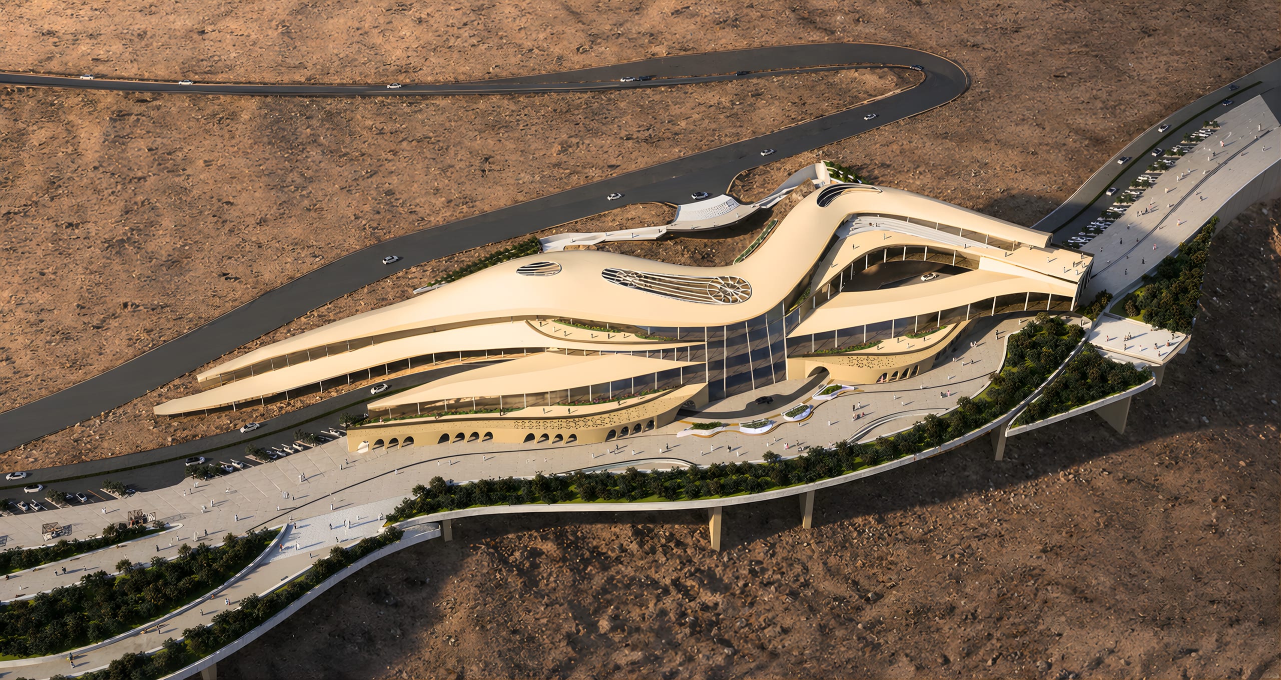 Bird’s-eye view of Maysalun Hub: a long curved building along the mountain road with terraces and a plaza below