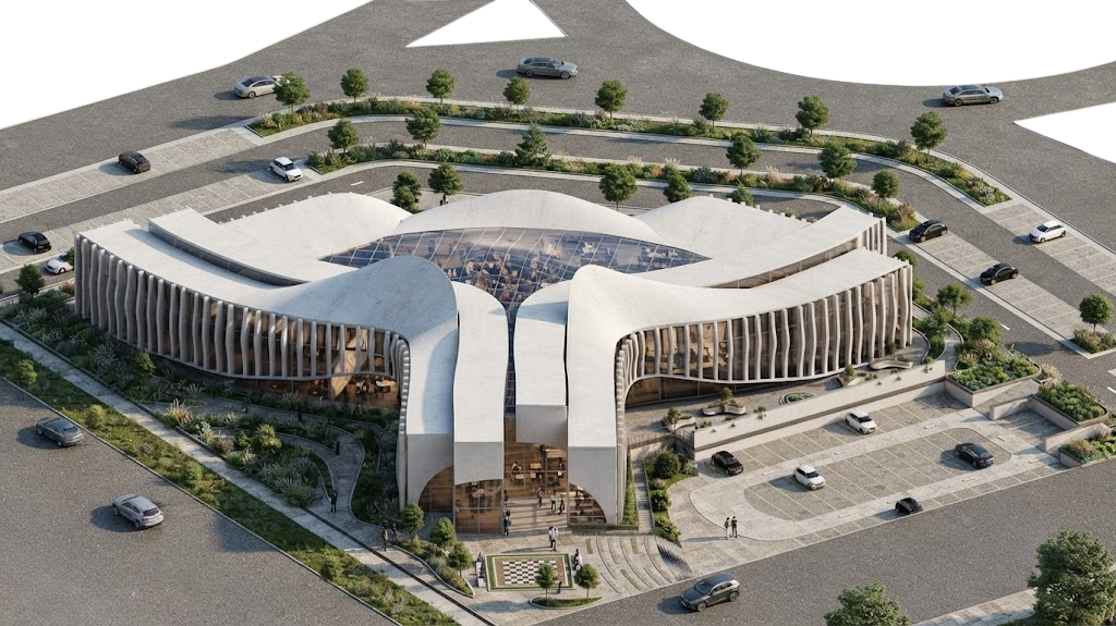 Aerial view from the south showing the main entrance between two roof wings and the chessboard plaza